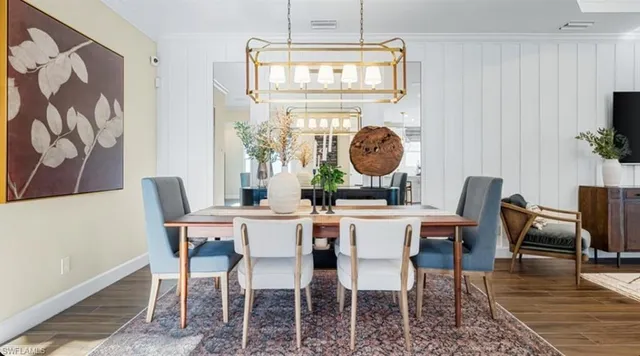 a view of a dining room with furniture wooden floor and chandelier