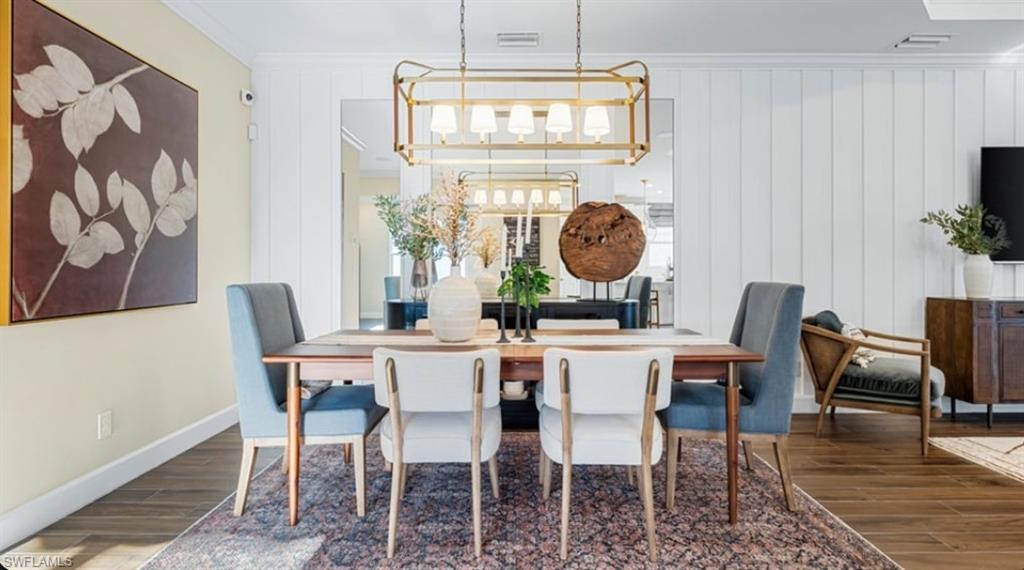 18073 Terracina Drive Fort Myers, FL 33913 - Photo 7 of 31 a dining room with furniture wooden floor and a rug