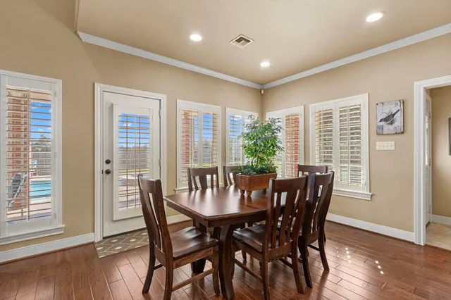 a view of a dining room with furniture window and wooden floor