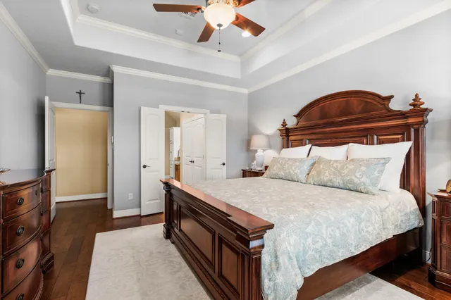a bedroom with a bed and a ceiling fan