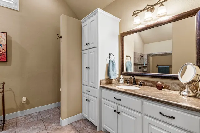 a bathroom with a double vanity sink and mirror