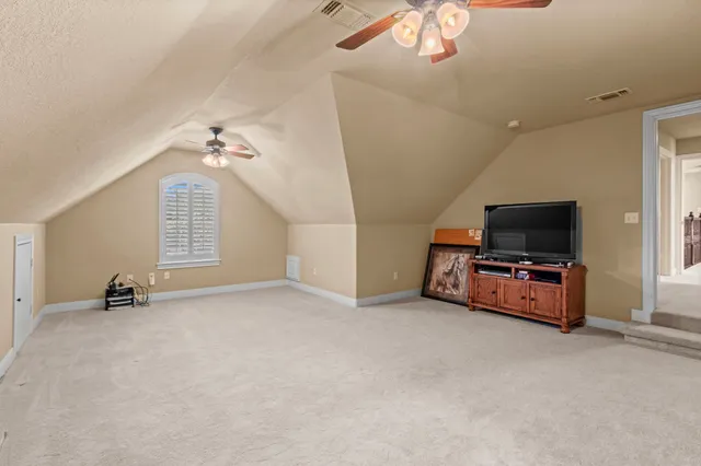 en empty room with windows and flat screen tv