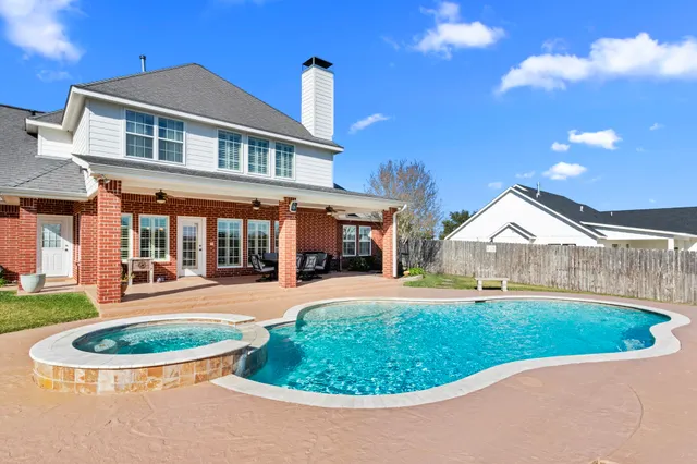 a view of a house with a swimming pool and yard