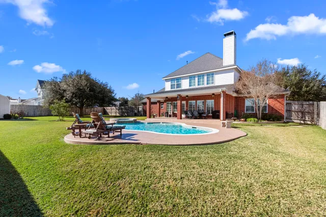 a view of a house with swimming pool and sitting area