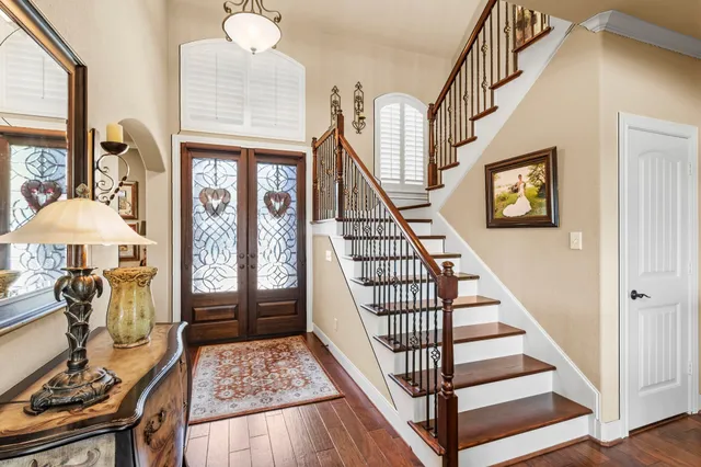 a view of entryway and hall with wooden floor