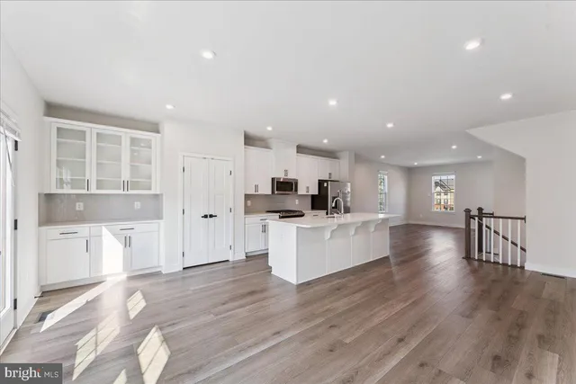 a view of kitchen with a sink and wooden floor