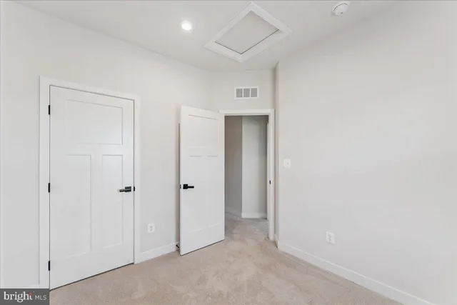 an empty room with windows and closet