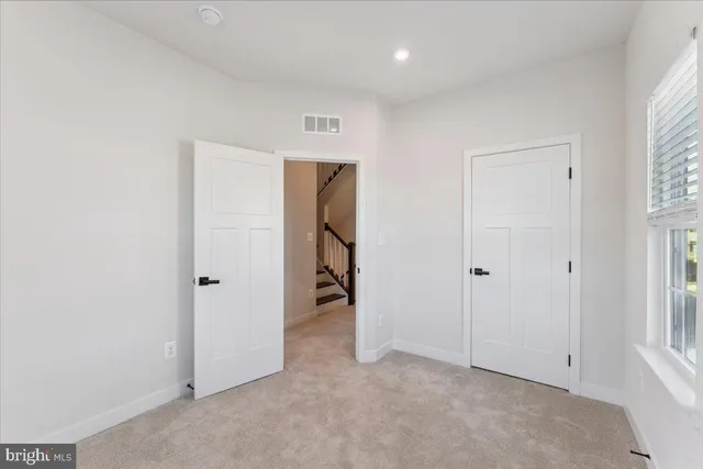 a view of a hallway with wooden floor and entryway