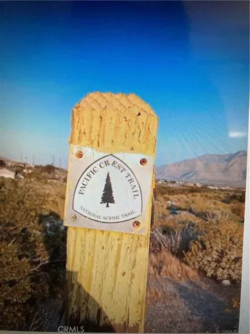 a view of a backyard with plants and lake view