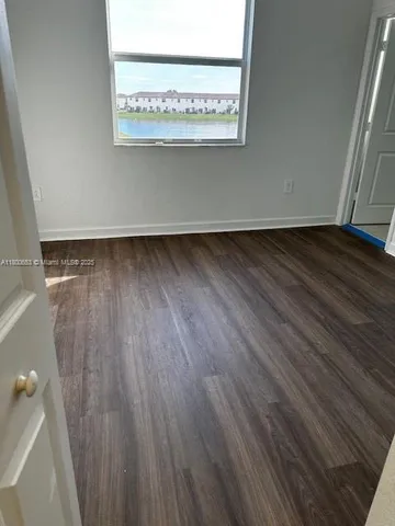 a view of a room with wooden floor