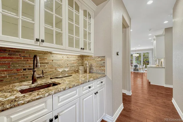 a view of a kitchen with granite countertop cabinets