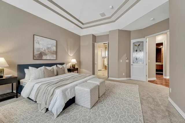 a bedroom with a bed and painting on the wall