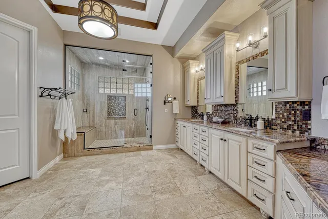 a large bathroom with a granite countertop sink mirror and a bathtub