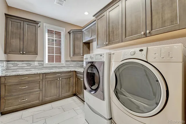 a utility room with sink dryer and washer