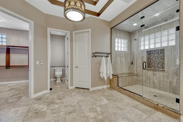 a view of a bathroom with a glass shower door and a sink