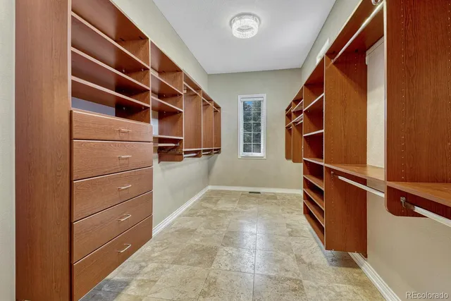 a view of walk in closet with empty racks