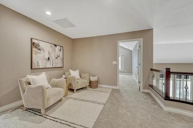 a living room with furniture and baby crib