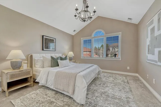 a bedroom with a bed and a chandelier