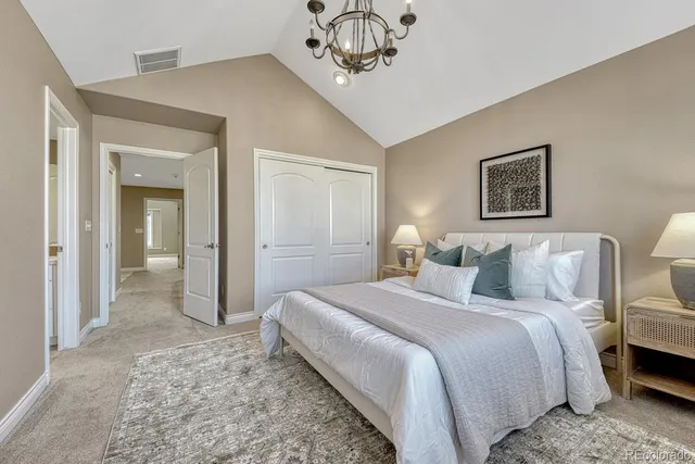 a bedroom with a bed and a chandelier