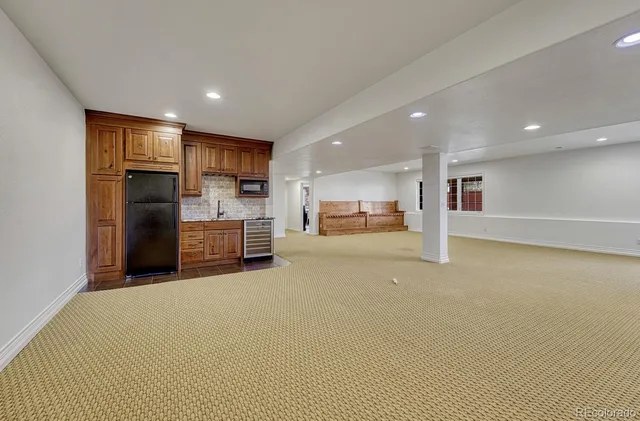 a view of kitchen with refrigerator and wooden floor
