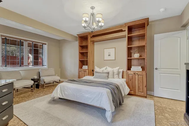 a bedroom with a bed wooden floor and window