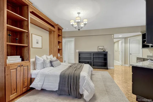 a spacious bedroom with a bed and a cabinets