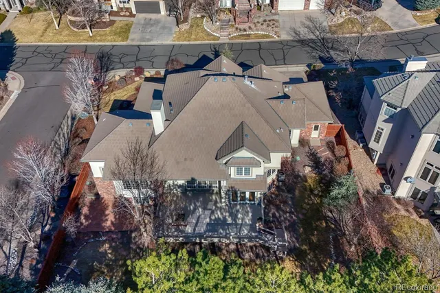 a view of a house with a yard and parking