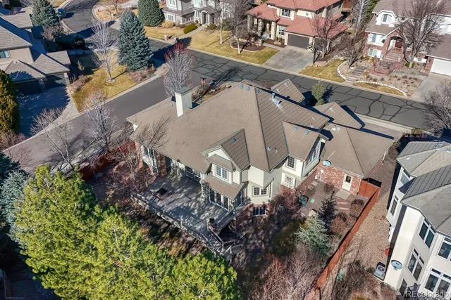 a view of a house with a yard and potted plants