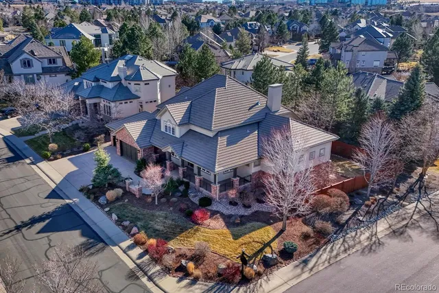 an aerial view of a house with yard swimming pool and outdoor seating