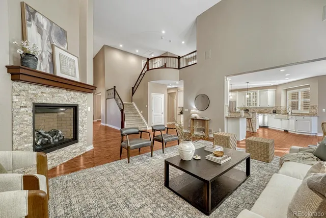a living room with furniture a fireplace and a table