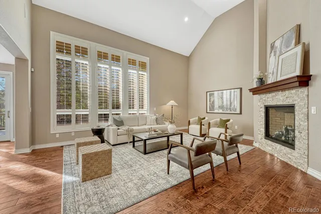 a living room with furniture large window and a fireplace