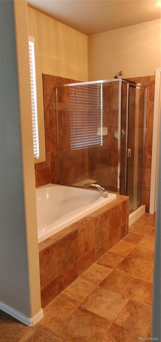 8108 Raspberry Drive Frederick, CO 80504 - Photo 12 of 16 a bathroom with a bathtub and shower