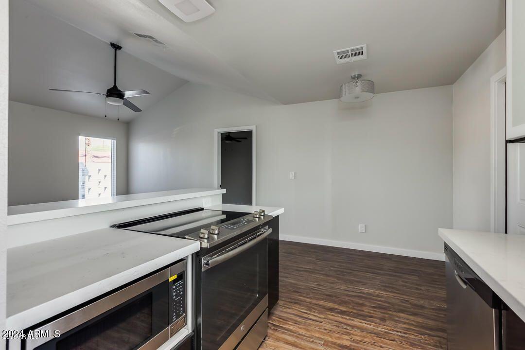 4229 North 17th Street Phoenix, AZ 85016 - Photo 11 of 20 a kitchen that has a stove and a wooden floor