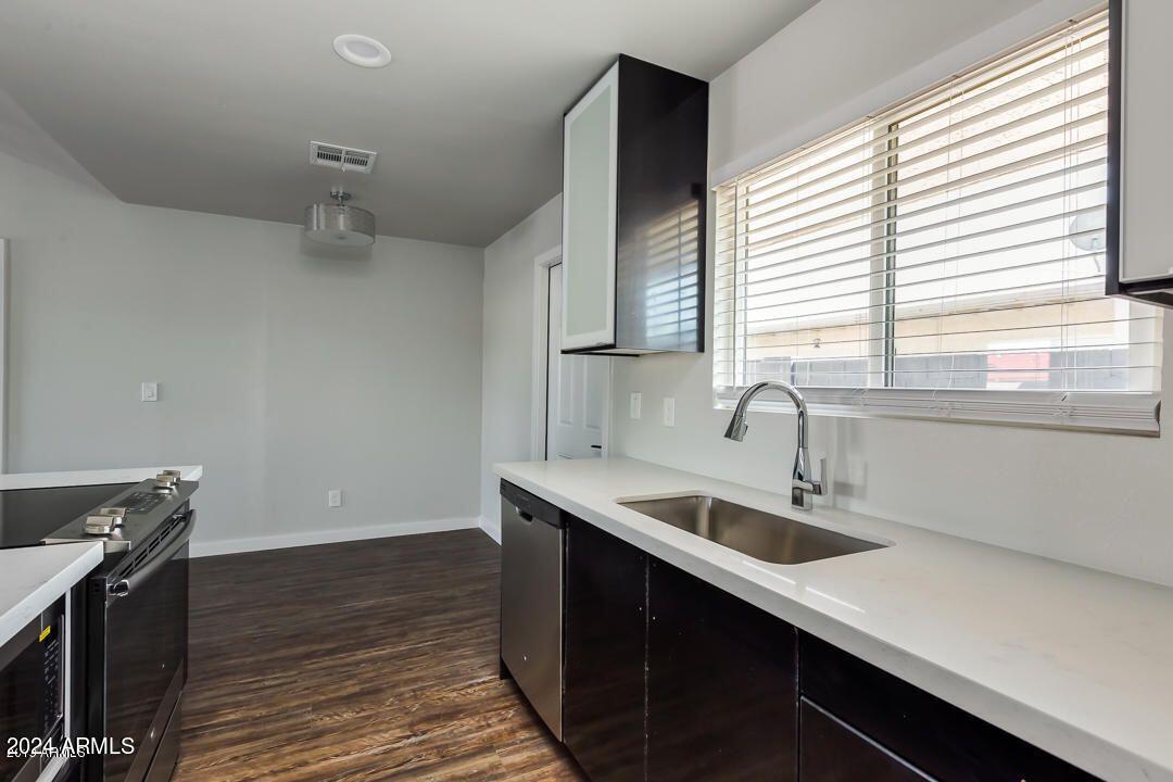 4229 North 17th Street Phoenix, AZ 85016 - Photo 12 of 20 a kitchen with a sink and wooden floor