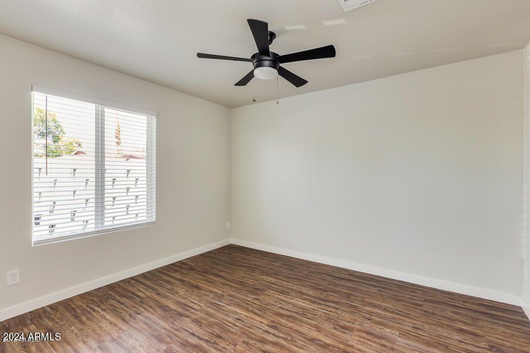 4229 North 17th Street Phoenix, AZ 85016 - Photo 13 of 20 a view of a room with wooden floor and a window