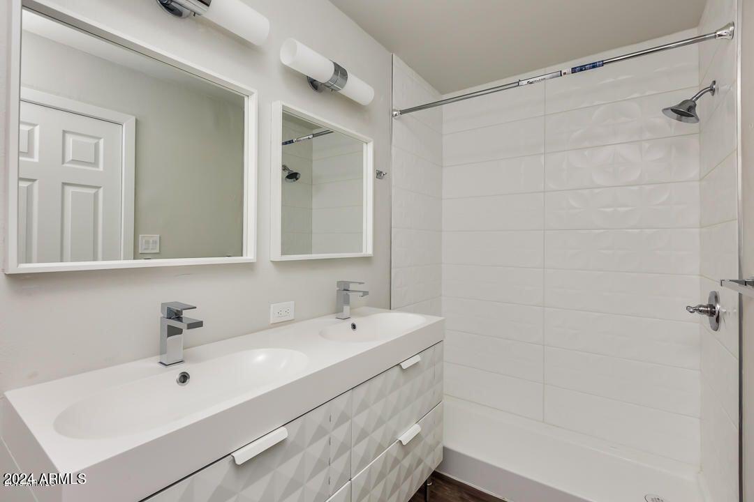 4229 North 17th Street Phoenix, AZ 85016 - Photo 15 of 20 a bathroom with a sink a mirror and shower