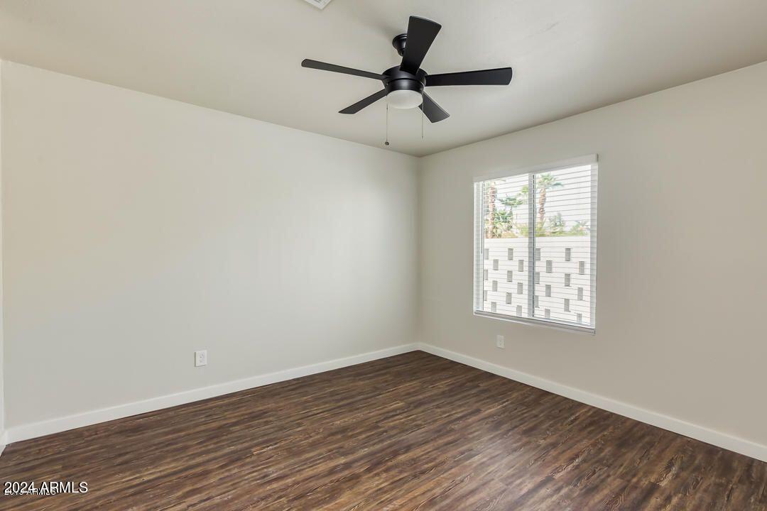 4229 North 17th Street Phoenix, AZ 85016 - Photo 16 of 20 a view of empty room with wooden floor and fan