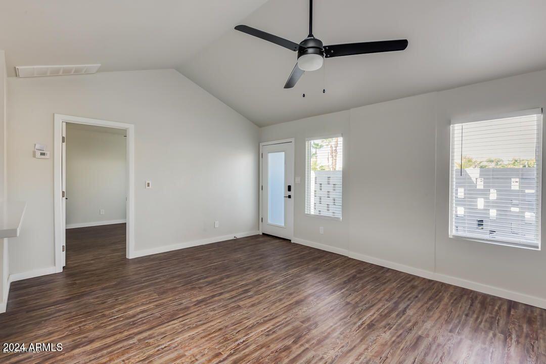 4229 North 17th Street Phoenix, AZ 85016 - Photo 7 of 20 a view of an empty room with wooden floor and a window