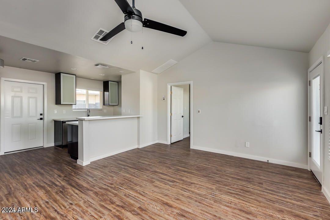 4229 North 17th Street Phoenix, AZ 85016 - Photo 8 of 20 a view of a kitchen with a sink and dishwasher with wooden floor