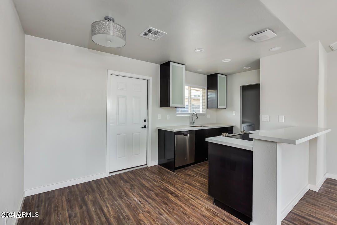 4229 North 17th Street Phoenix, AZ 85016 - Photo 9 of 20 a kitchen with stainless steel appliances granite countertop a sink stove and cabinets