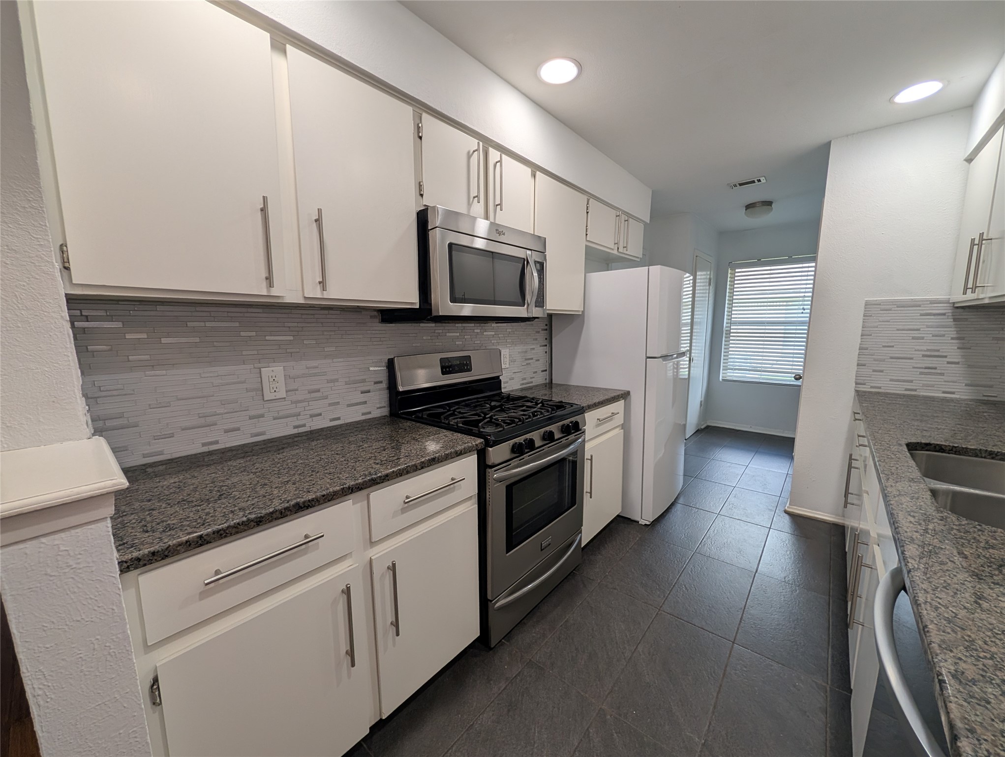 4601 Tamarack Trail Austin, TX 78727 - Photo 10 of 19 An inviting kitchen with granite counters and contemporary stainless steel appliances awaits culinary adventures.
