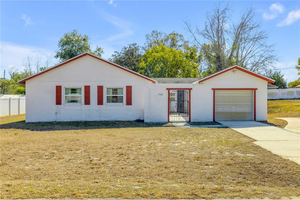 a view of a house with a garden and yard