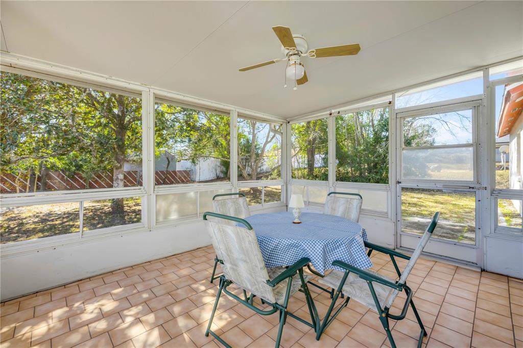 1981 South Merrick Drive Deltona, FL 32738 - Photo 19 of 30 a view of a dining room with furniture large windows and wooden floor