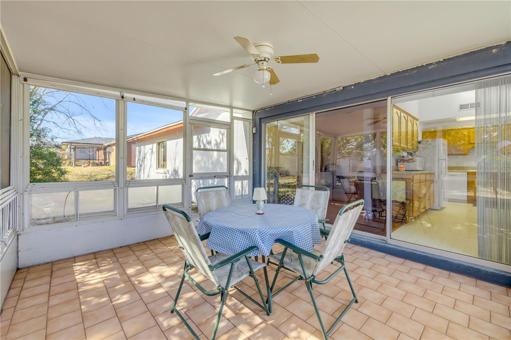 1981 South Merrick Drive Deltona, FL 32738 - Photo 20 of 30 a view of a dining room with furniture large windows and wooden floor