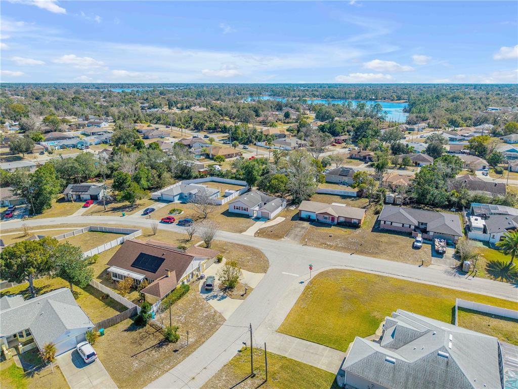 1981 South Merrick Drive Deltona, FL 32738 - Photo 25 of 30 a view of a swimming pool with a lounge chair and tables