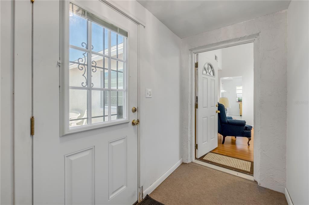 1981 South Merrick Drive Deltona, FL 32738 - Photo 5 of 30 a view of a hallway and a livingroom with furniture
