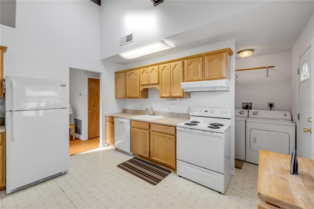 1981 South Merrick Drive Deltona, FL 32738 - Photo 10 of 30 a kitchen with a refrigerator sink and cabinets