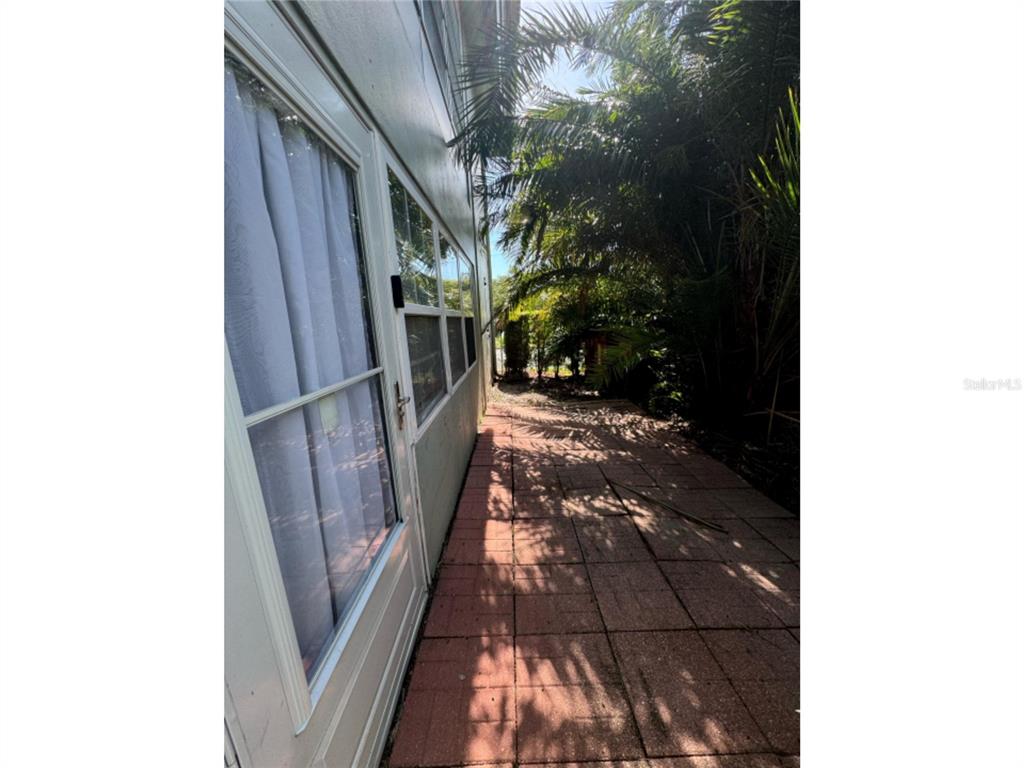 1433 South Belcher Road, Unit C1 Clearwater, FL 33764 - Photo 26 of 27 a view of a pathway of a house