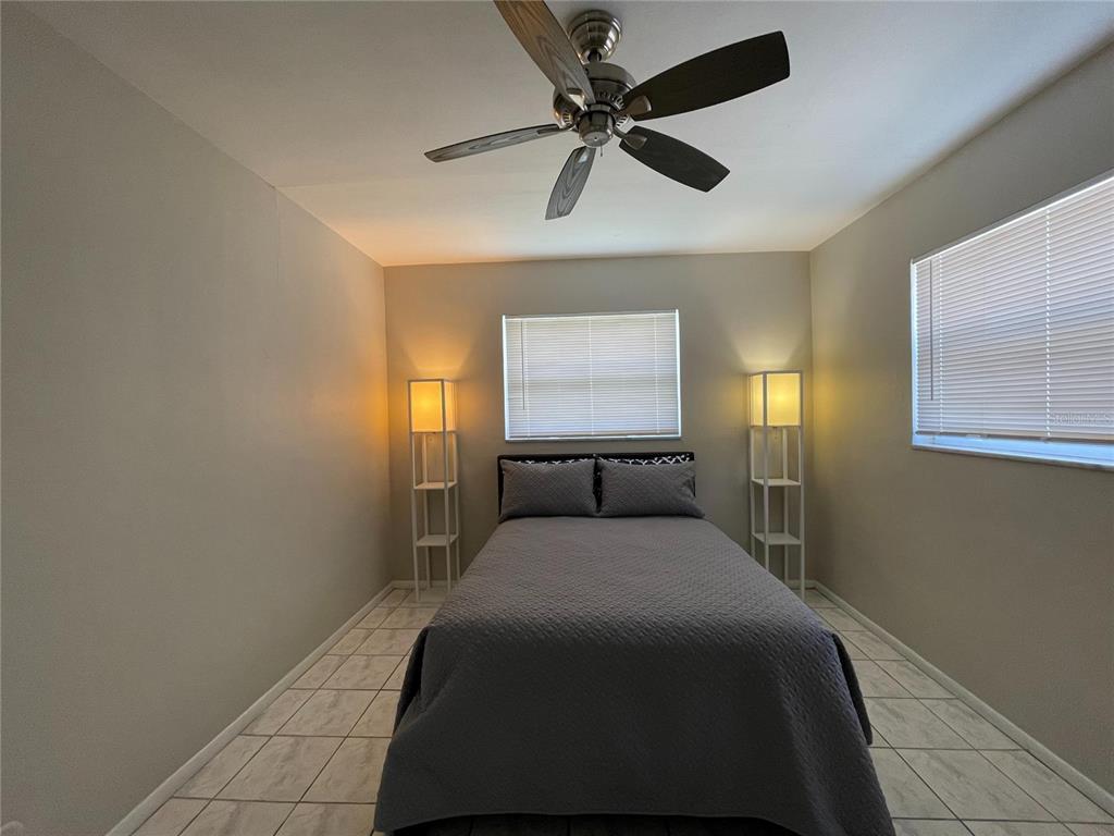 1433 South Belcher Road, Unit C1 Clearwater, FL 33764 - Photo 4 of 27 a bedroom with a bed and a window