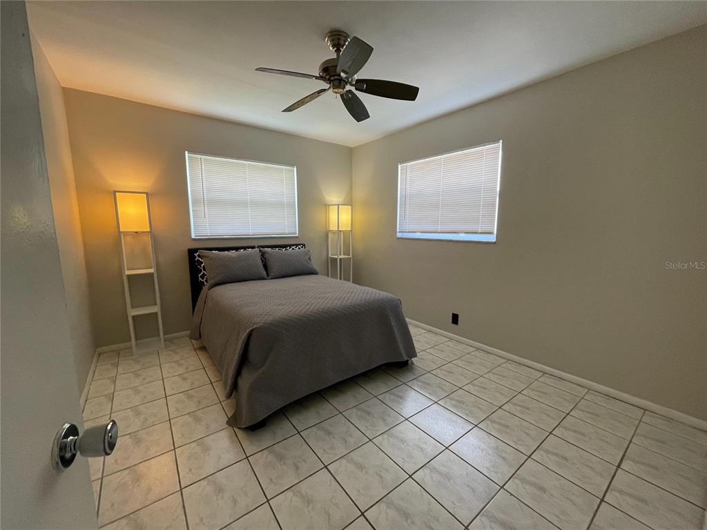 1433 South Belcher Road, Unit C1 Clearwater, FL 33764 - Photo 5 of 27 a bedroom with a bed and a window
